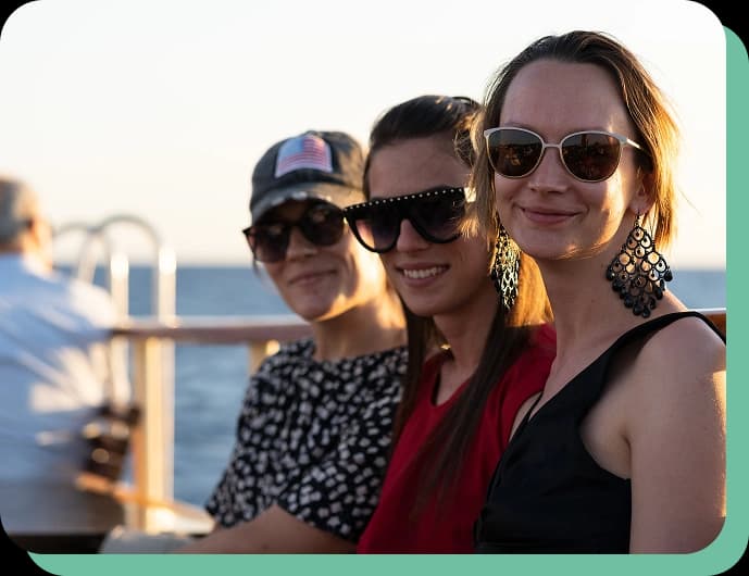 Attendees enjoying a networking activity on a boat at sunset